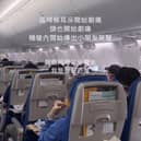 Passengers hold oxygen masks to their faces after their plane dropped 26,900ft.