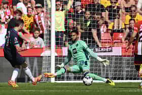 Tottenham Hotspur player James Maddison has his shot saved by Sheffield United goalkeeper Wes Foderingham