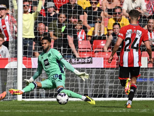 Tottenham Hotspur player James Maddison has his shot saved by Sheffield United goalkeeper Wes Foderingham