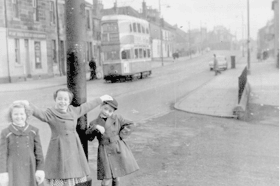 3 young girls pose for a picture on Baillieston Main Street
