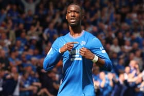 Abdallah Sima of Rangers points to the club's badge