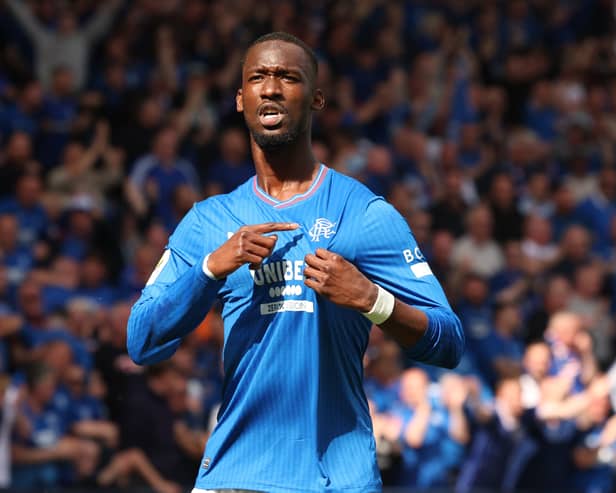 Abdallah Sima of Rangers points to the club's badge