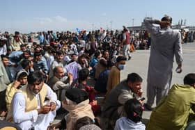 Afghan passengers waiting to leave Kabul’s airport. Pic: Wakil Kohsar/AFP via Getty Images.