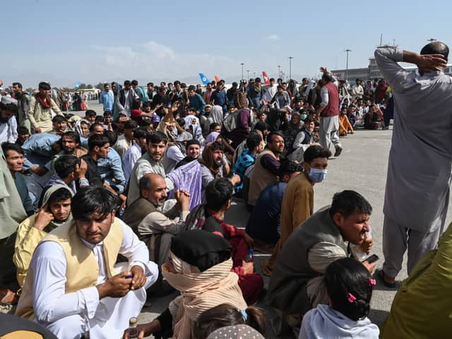 Afghan passengers waiting to leave Kabul’s airport. Pic: Wakil Kohsar/AFP via Getty Images.