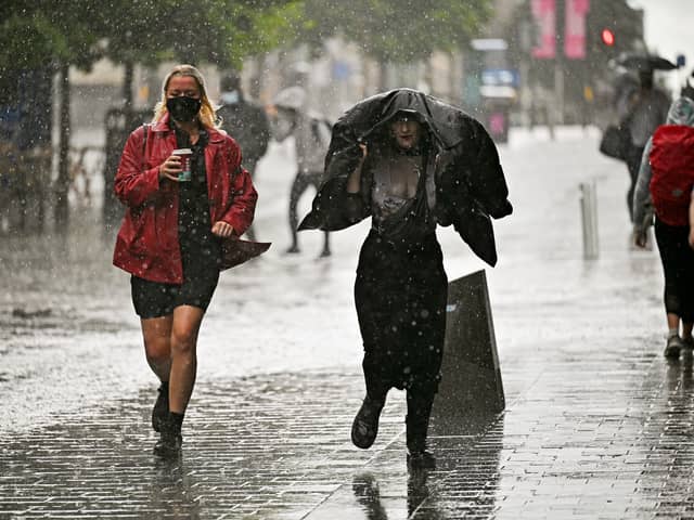 Members of the public make their way through the rain on Sauchiehall Street at the beginning of August.