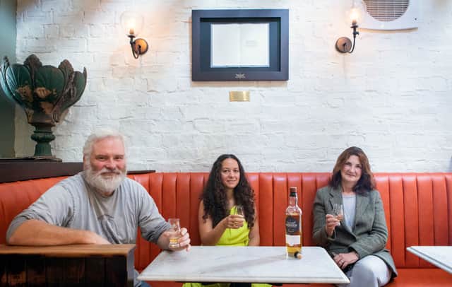 L-R Ubiquitous Chip owner Colin Clydesdale, poet Jeda Pearl and Carol Clydesdale with Glengoyne literary artwork