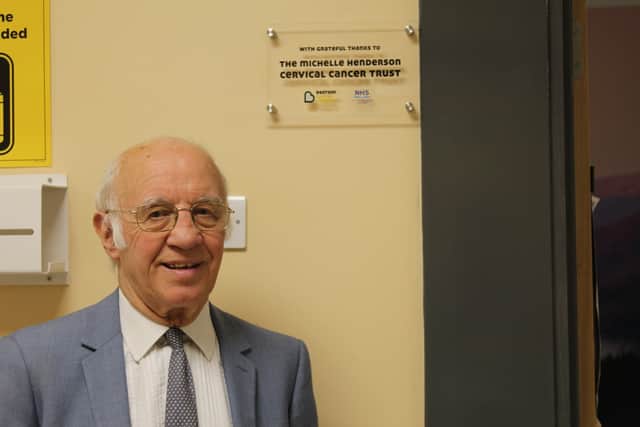Willie Henderson with plaque which has been placed outside the treatment rooms