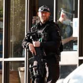 A police firearms officer is seen at the scene of a stabbing incident at Belfairs Methodist Church in Leigh-on-Sea, a district of Southend-on-Sea, in southeast England on October 15, 2021. - Conservative British lawmaker David Amess was killed on Friday after being stabbed "multiple times" during an event in his local constituency in southeast England, in the second death of a UK politician while meeting voters since 2016. Local police did not name Amess but said a man had been arrested "on suspicion (of) murder" after the stabbing in Leigh-on-Sea. (Photo by Tolga Akmen / AFP) (Photo by TOLGA AKMEN/AFP via Getty Images)
