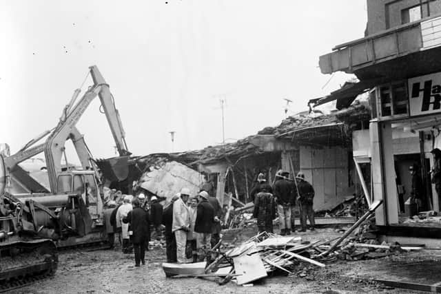 Firemen check the debris of the collapsed shops after the Clarkston Toll gas explosion in October 1971.