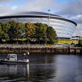 Police Scotland officers patrol past the SSE Hydro venue in Glasgow as the city prepares to host the COP26 UN Climate Summit in November.  (Photo by Andy Buchanan / AFP) (Photo by ANDY BUCHANAN/AFP via Getty Images)