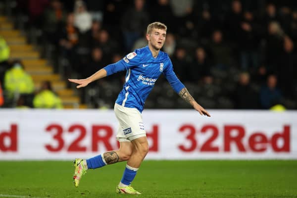 Riley Mcgree of Birmingham City urges the away supporters to stop throwing bottles onto the pitch during the Sky Bet Championship match between Hull City and Birmingham City