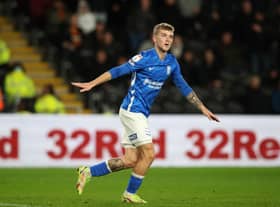 Riley Mcgree of Birmingham City urges the away supporters to stop throwing bottles onto the pitch during the Sky Bet Championship match between Hull City and Birmingham City