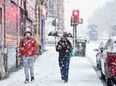  Members of the public make their way through a snow shower in Glasgow’s  West End in 2019.  (Photo by Jeff J Mitchell/Getty Images)