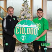 Celtic manager Ange Postecoglou and defender Greg Taylor hand over the £10,000 donation