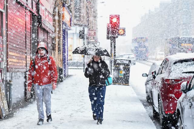 People walking in the snow in Glasgow in 2019. (Photo by Jeff J Mitchell/Getty Images)