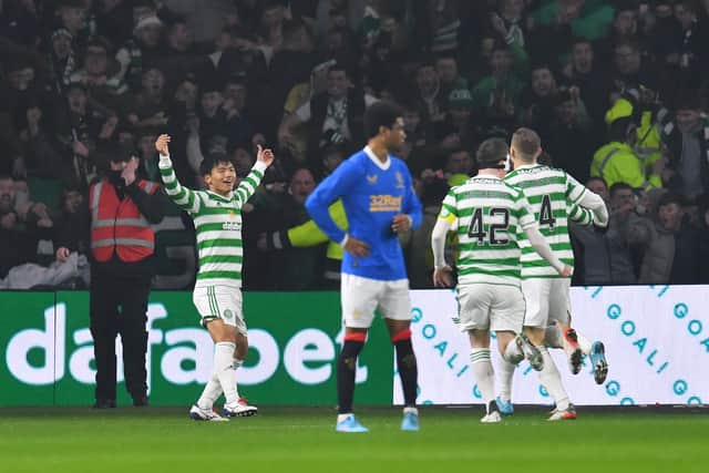   Reo Hatate of Celtic celebrates with team-mates after scoring the opening goal during the Cinch Scottish Premiership match between Celtic FC and Rangers FC at  on February 02, 2022 in Glasgow, Scotland
