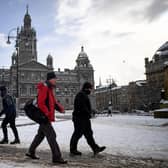 Members of the public make their way through the snow in Glasgow in February 2021. (Photo by Jeff J Mitchell/Getty Images)