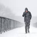 Members of the public make their way through the snow in Glasgow this time last year. (Photo by Jeff J Mitchell/Getty Images)