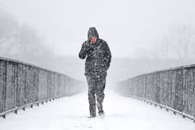 Members of the public make their way through the snow in Glasgow this time last year. (Photo by Jeff J Mitchell/Getty Images)