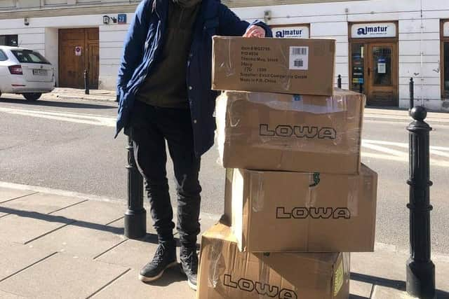 Glasgow University graduate Oleksii Rudenko with some boxes of equipment.