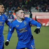 : Ryan Kent of Rangers celebrates with team mate James Tavernier after scoring their sides first goal during the UEFA Europa League Round of 16 Leg Two match between Crvena Zvezda and Rangers FC at Rajko Mitic Stadium on March 17, 2022 in Belgrade, Serbia