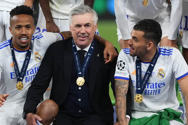 Carlo Ancelotti, Head Coach of Real Madrid interacts with Eder Militao and Dani Ceballos of Real Madrid following their sides victory in the UEFA Champions League final match between Liverpool FC and Real Madrid at Stade de France on May 28, 2022 in Paris, France. (Photo by Shaun Botterill/Getty Images)