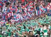 Celtic and Rangers supporters get behind their sides (Photo by Steve  Welsh/Getty Images)