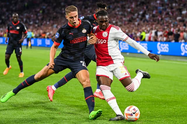 PSV Eindhoven’s Dutch midfielder Joey Veerman (CL) fights for the ball with Ajax’s Nigerian defender Calvin Bassey during the 26th Johan Cruijff Shield match between PSV Eindhoven and Ajax Amsterdam during the Dutch Super Cup at the Johan Cruyff Arena in Amsterdam, on July 30, 2022.