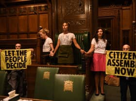 Handout photo taken with permission from the twitter feed of Extinction Rebellion of protesters who have superglued themselves around the Speaker's chair in the House of Commons chamber, as they call for a Citizen's Assembly. Picture date: Friday September 2, 2022.