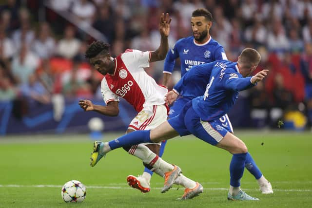  Mohammed Kudus of Ajax is challenged by Connor Goldson and John Lundstram of Rangers during the UEFA Champions League group A match between AFC Ajax and Rangers