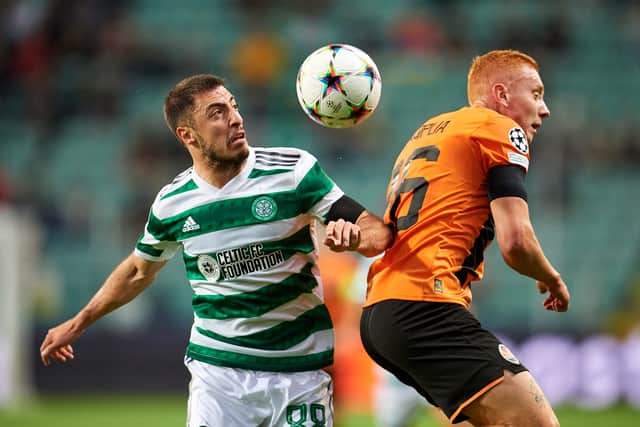 Yukhym Konoplia from FC Shakhtar Donetsk fights for the ball with Josip Juranovic from Celtic