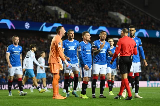 Players of Rangers FC contest the third penalty kick with Match Referee, Antonio Mateu Lahoz