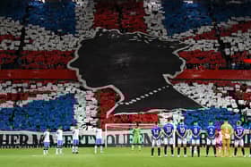 Rangers’ and Napoli’s player observe a minute’s silence to mark the death of Britain’s Queen Elizabeth II ahead of the UEFA Champions League Group A football match between Scotland’s Rangers and Italy’s Napoli at Ibrox stadium in Glasgow, on September 14, 2022. (Photo by ANDY BUCHANAN / AFP) (Photo by ANDY BUCHANAN/AFP via Getty Images)