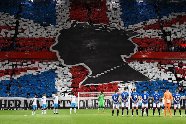 <p>Rangers’ and Napoli’s player observe a minute’s silence to mark the death of Britain’s Queen Elizabeth II ahead of the UEFA Champions League Group A football match between Scotland’s Rangers and Italy’s Napoli at Ibrox stadium in Glasgow, on September 14, 2022. (Photo by ANDY BUCHANAN / AFP) (Photo by ANDY BUCHANAN/AFP via Getty Images)</p>