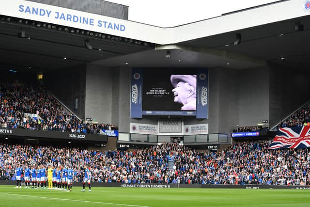 Rangers players observe a minute of silence before kick off to pay tribute to Her Majesty Queen Elizabeth II, who died at Balmoral Castle on September 8, 2022.