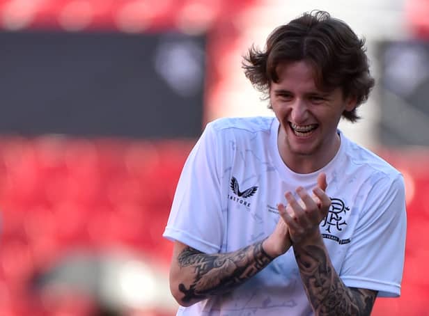 <p>Midfielder Alex Lowry laughs as he takes part in a training session, on the eve of the Europa League final</p>