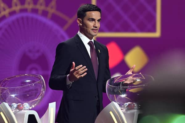 Former Australian footballer Tim Cahill speaks on stage during the draw for the 2022 World Cup in Qatar at the Doha Exhibition and Convention Center 