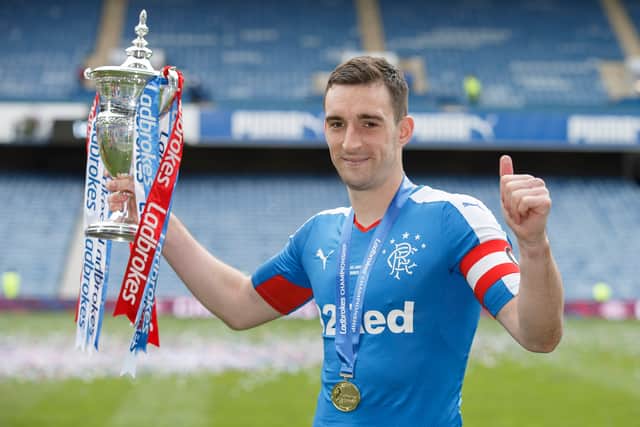 Lee Wallace the Rangers Captain  lifts the Scottish Championship Trophy at Ibrox Stadium