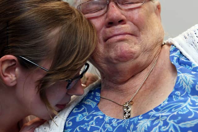 Winnie Johnson, the mother of Saddleworth Moor murder victim Twelve-year-old Keith Bennett, is consoled by her friend Elizabeth Bond, as she watches TV coverage of Greater Manchester Police announcing that the search for his body is now entering a dormant phase on July 1, 2009.