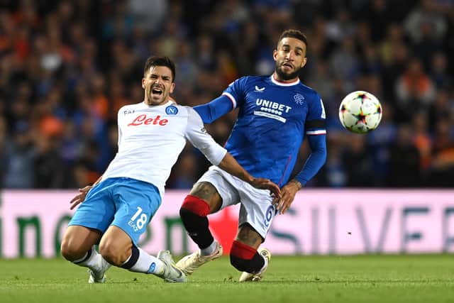 Napoli player Giovanni Simeone is challenged by Connor Goldson during the UEFA Champions League group A match 
