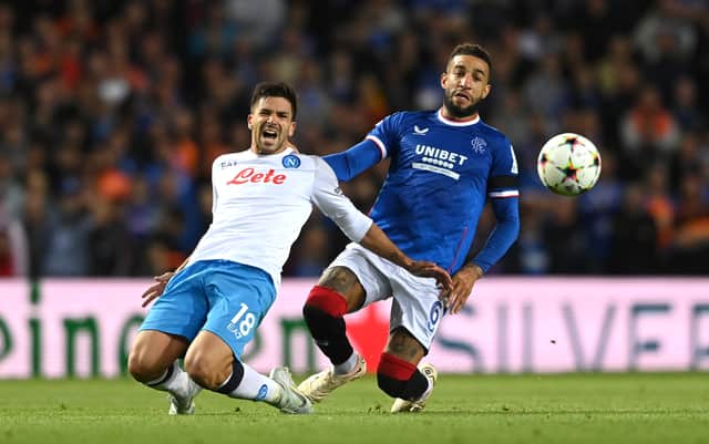 Napoli player Giovanni Simeone is challenged by Connor Goldson during the UEFA Champions League group A match 