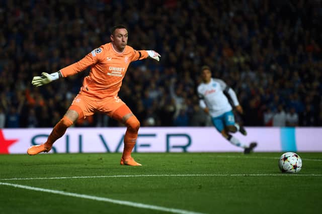 Allan McGregor attempts to stop the ball after saving a penalty that was later invalidated by the VAR and forced to be retaken, during the UEFA Champions League Group A football match between Rangers and Napoli at Ibrox stadium