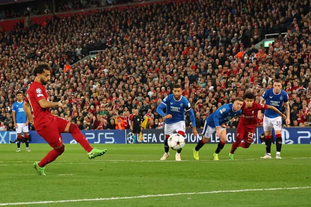 Liverpool's Egyptian striker Mohamed Salah (L) shoots from the penalty spot to score their second goal