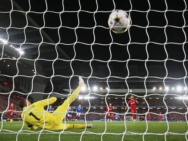 Rangers’ Scottish goalkeeper Allan McGregor (L) dives as Liverpool’s Egyptian striker Mohamed Salah (C) shoots to score from the penalty spot 