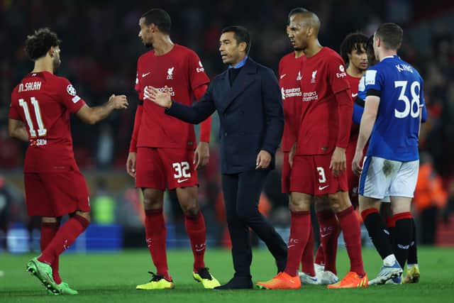 Mohamed Salah of Liverpool interacts with Giovanni van Bronckhorst, Manager of Rangers after the UEFA Champions League group A match