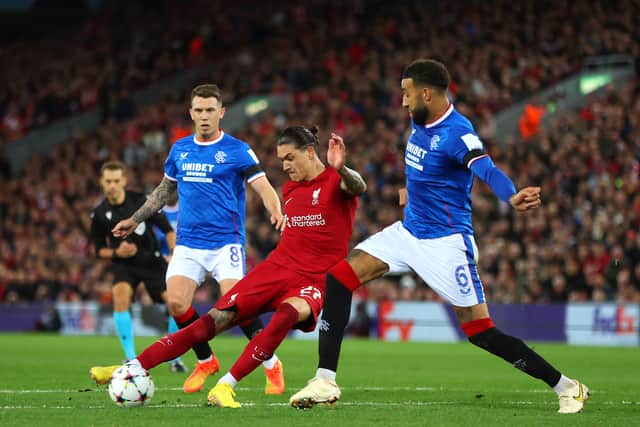 Darwin Nunez of Liverpool shoots under pressure from Ryan Jack and Connor Goldson of Rangers during the UEFA Champions League group A match 
