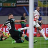 Celtic's English goalkeeper Joe Hart (L) and Celtic's Croatian defender Josip Juranovic fail to stop Leipzig's French midfielder Christopher Nkunku (R) from scoring