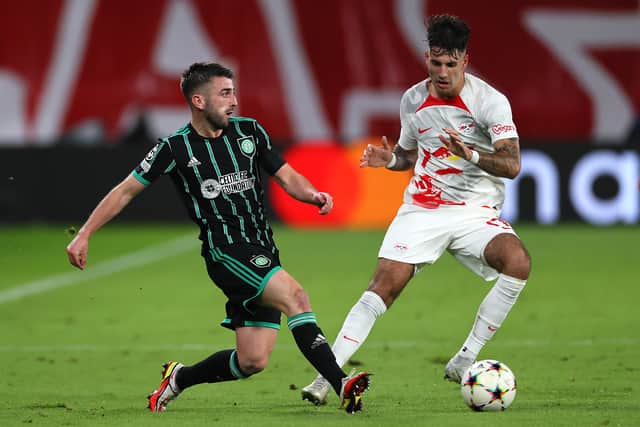 Greg Taylor of Celtic is challenged by Dominik Szoboszlai of RB Leipzig