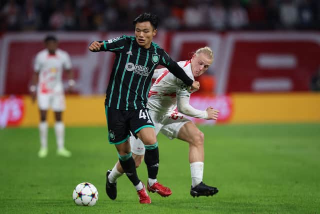 Celtic's Japanese defender Reo Hatate and Leipzig's Austrian midfielder Xaver Schlager (R) vie for the ball 