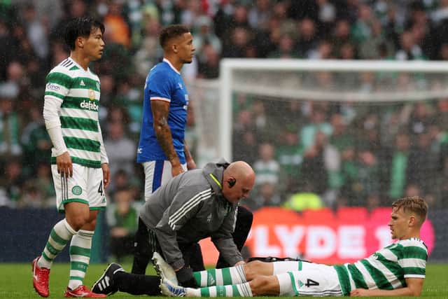 Carl Starfelt receives medical treatment during the Cinch Scottish Premiership match between Celtic and Rangers